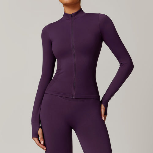 Purple athletic jacket and leggings set on a neutral background